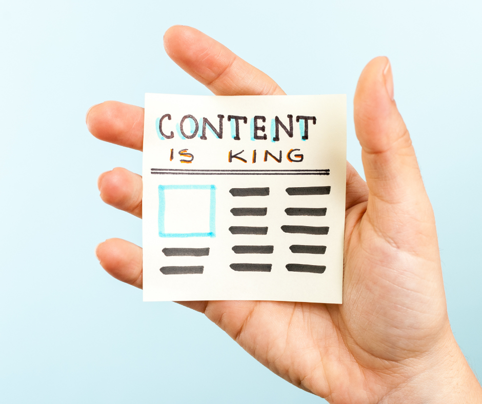 A sticky note that says "content is king".