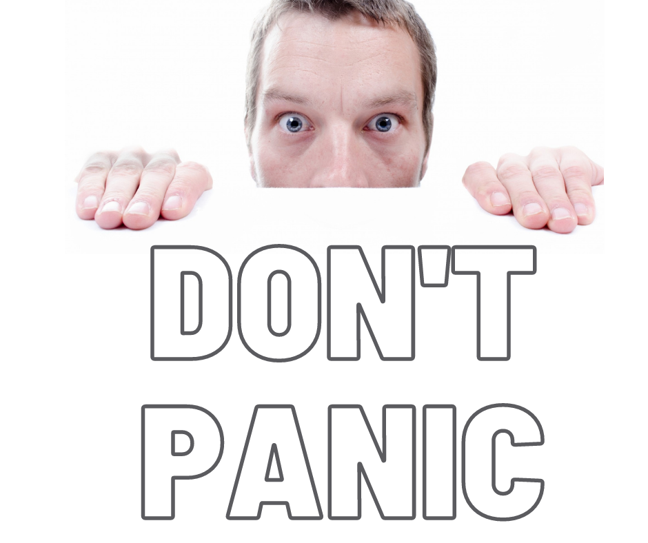 End of Life for PHP 7.4 - Guy holding a sign that says "Don't Panic."